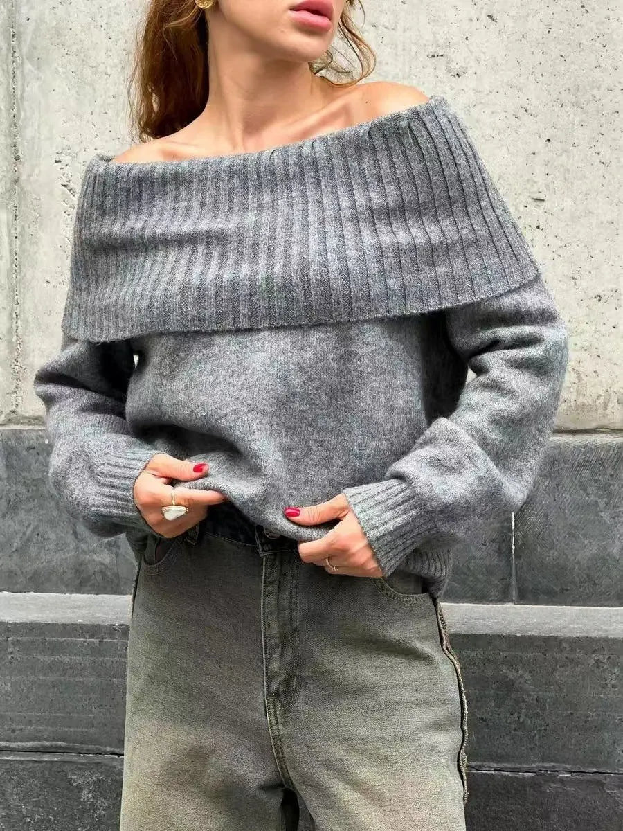 Grey off-the-shoulder sweater with a 3D textured pattern and strapless design.