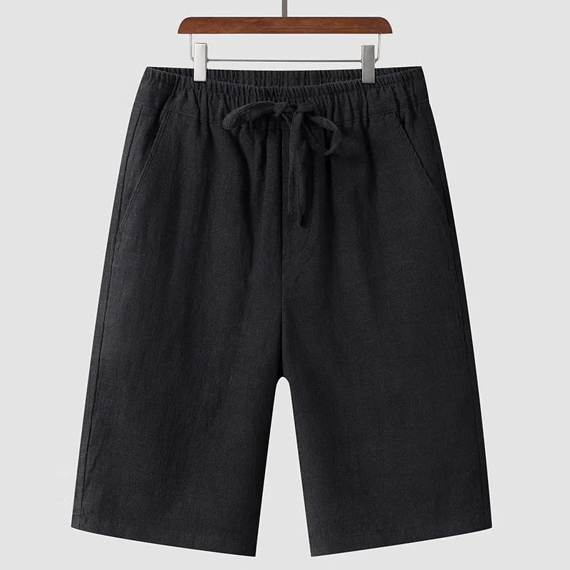Man wearing beige linen cropped shorts with a loose fit and elasticated waist
