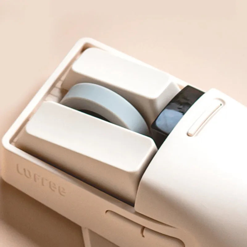 Xiaoqiao tofu-coloured wireless mouse with multiple buttons beside its Type-C charging cable and wireless receiver.