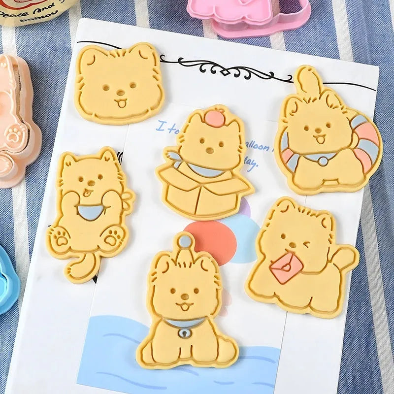 Three dimensional plastic biscuit mould showing puppy cartoon designs including birthday hats and swimming rings