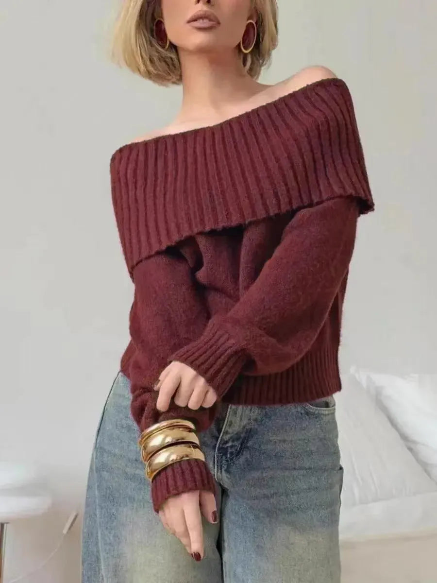 Grey off-the-shoulder sweater with a 3D textured pattern and strapless design.