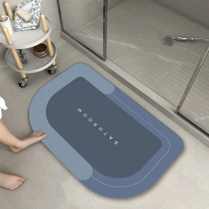 Soft blue oval bathroom floor mat placed on tiles beside a bathtub.