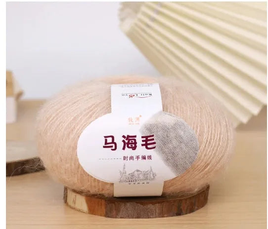 DIY mohair scarf weaving kit showing one wool ball and a selection of 34 colour options including white, pink, blue and green.