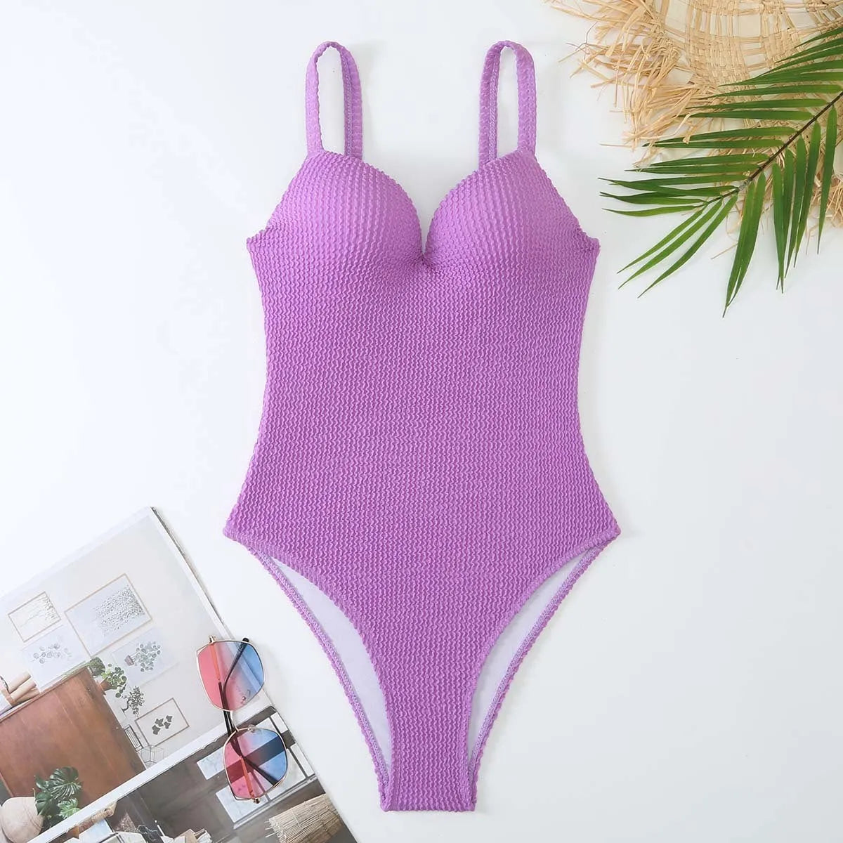 A women's sleeveless one-piece swimsuit on a hanger, shown in black, with other colour options available.