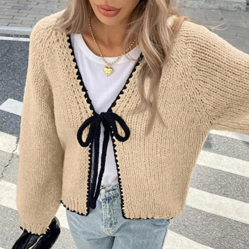 Grey lace-up sweater cardigan with long sleeves, a front crocheted flower, and a loose fit.