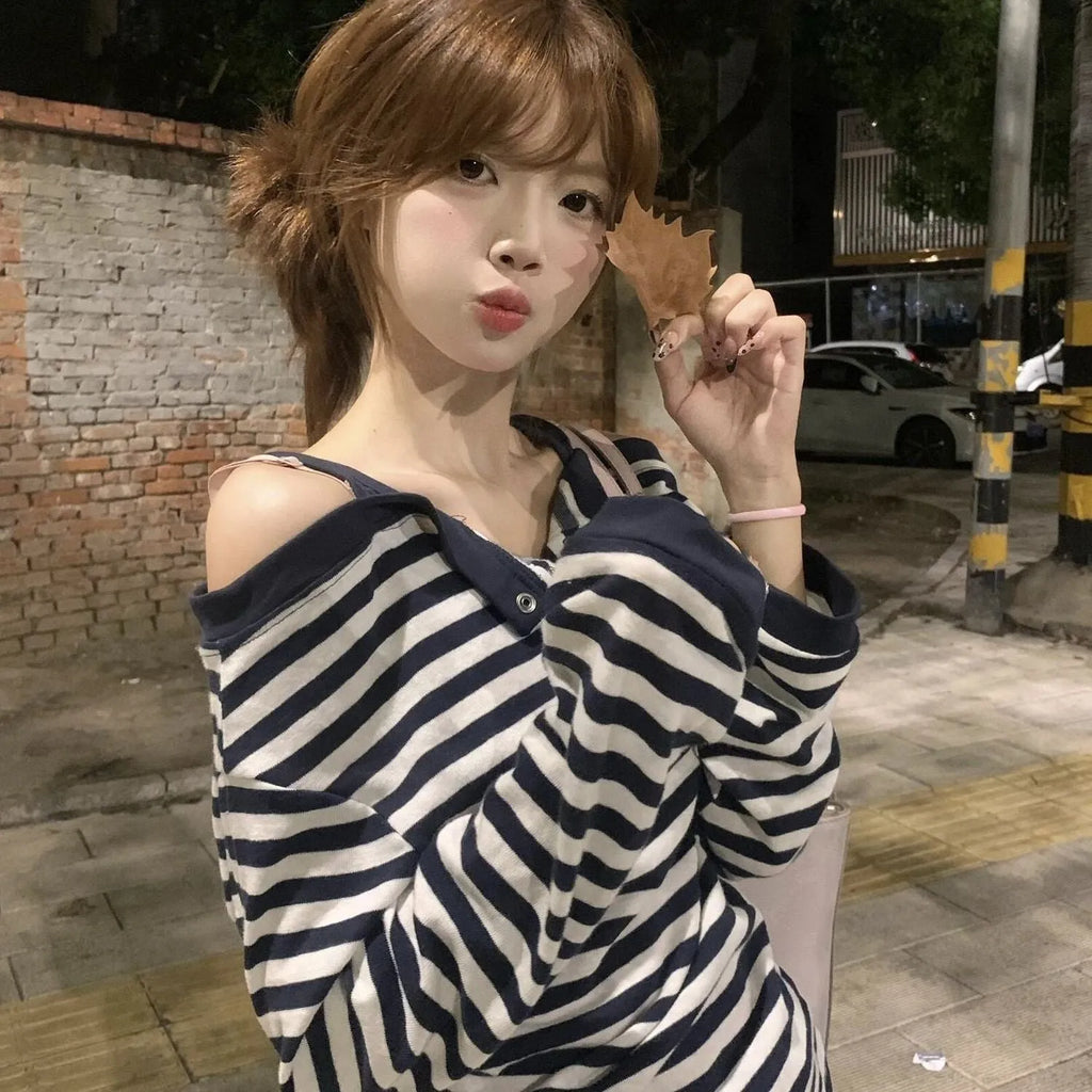 Dark blue Korean-style oversized women's long-sleeved t-shirt with embroidered stripes and button details.