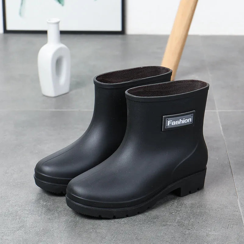 Women's black PVC rain boots with mid-calf height and low heel