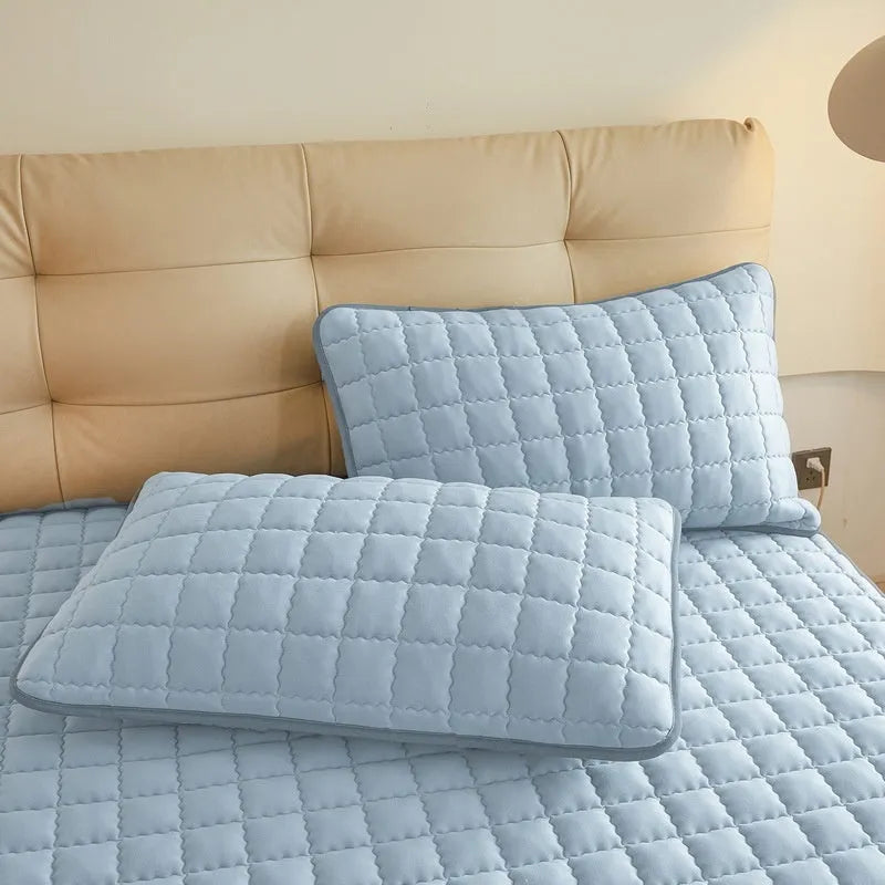 Class A waterproof fitted sheet in light grey colour, shown fitted neatly on a mattress.