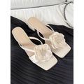 Women's chunky heel square toe sandals with satin upper and flower detail in cream-white