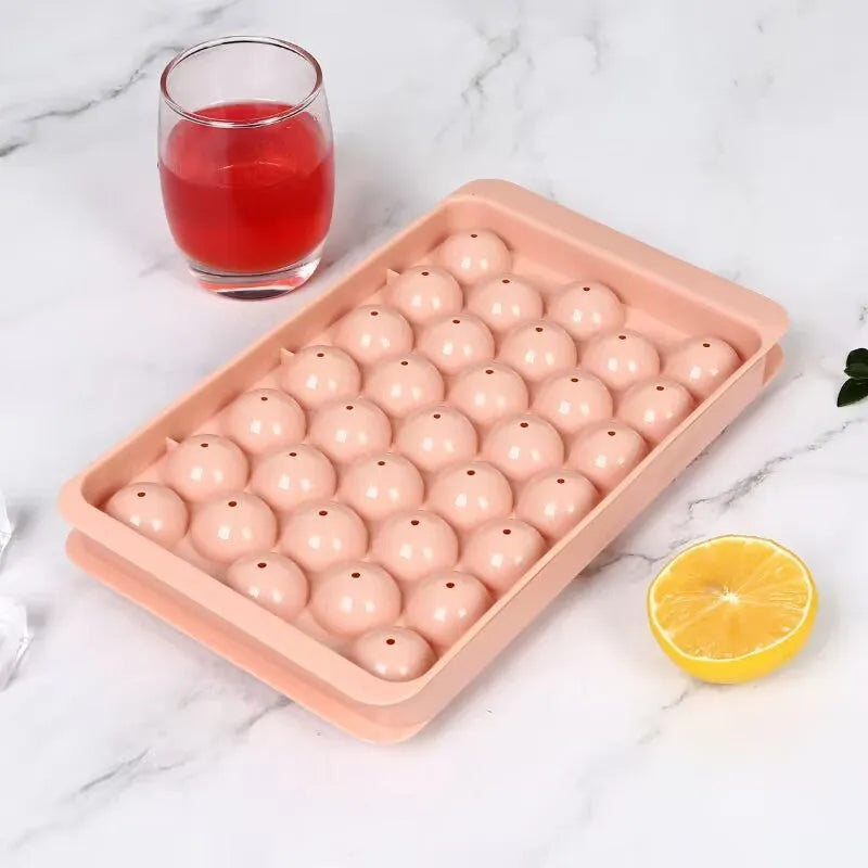 Blue silicone ice cube tray with lid showing 33 round moulds