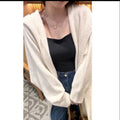 Women's long hooded cardigan in wool blend fabric showing below-the-knee length and loose fit silhouette