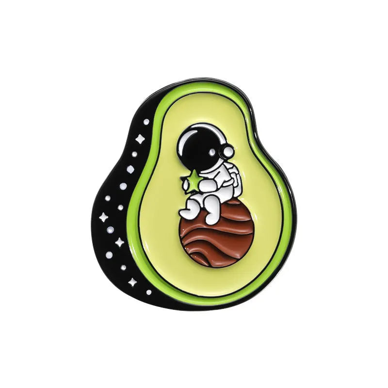 Colourful cartoon fruit design metal brooch pin on a fabric background.