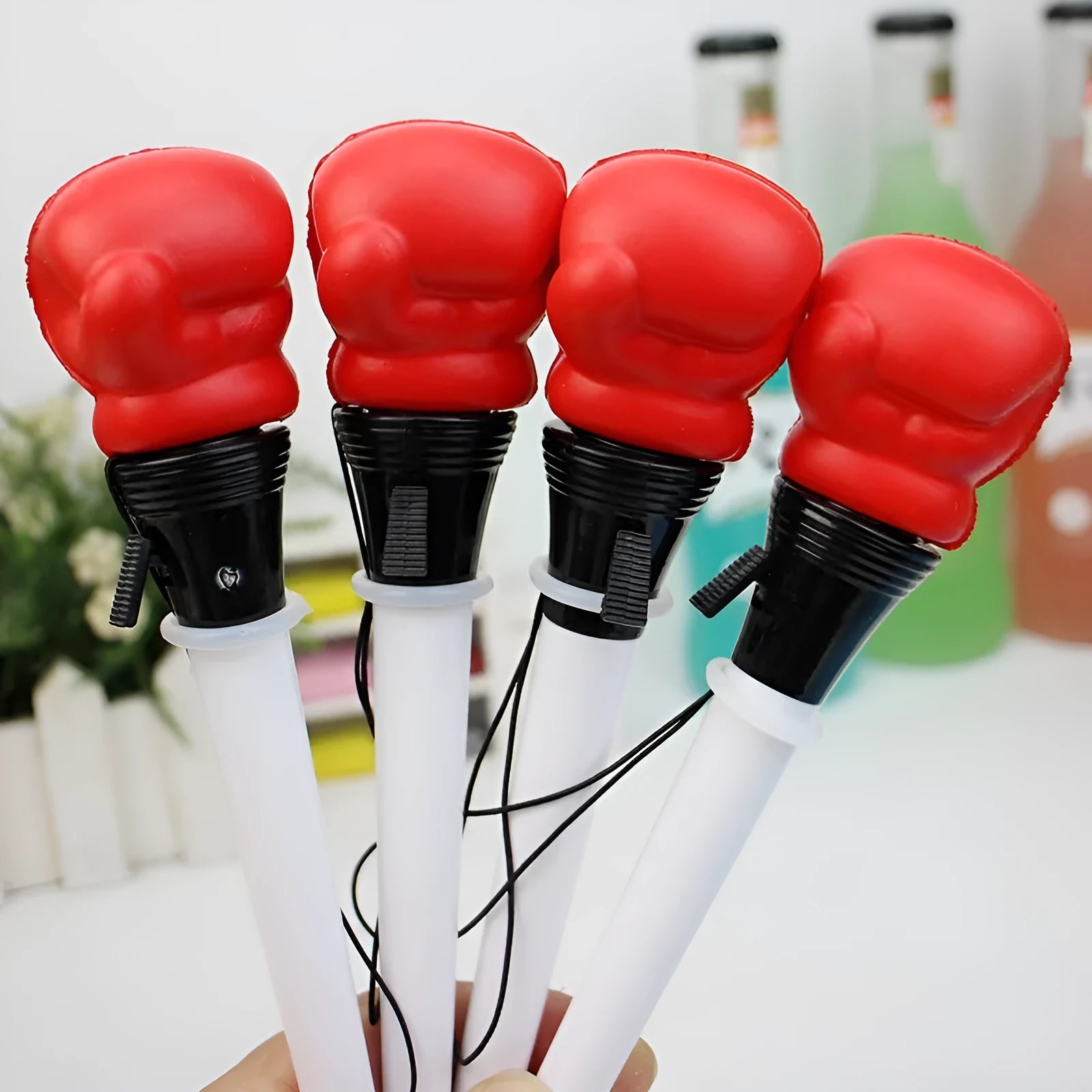 Boxing press ejection pen set showing four pens with plug-in sleeve mechanism and 0.7mm bullet-shaped tips