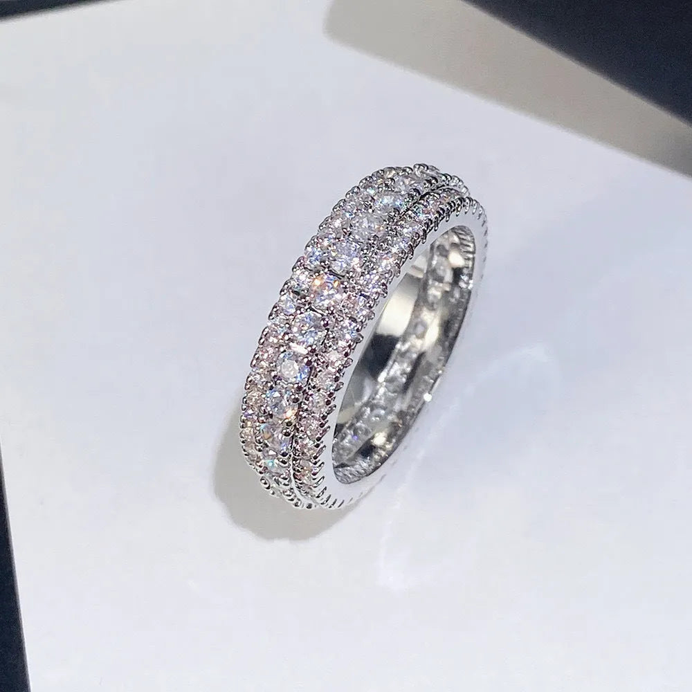 Geometric copper ring with triangular zircon stone, shown in white gold, yellow gold, and white and black finish options.