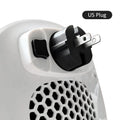 White ceramic heating electric blower with remote control on a desk.