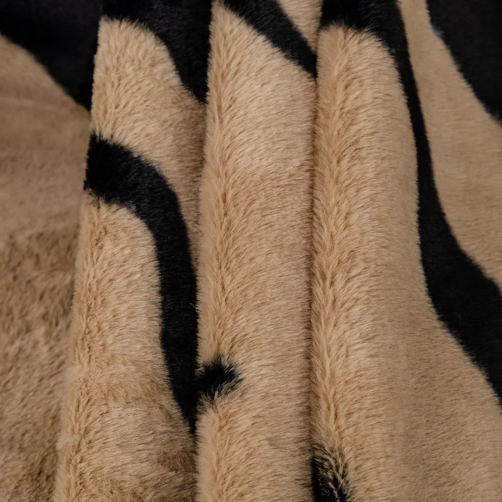 Zebra pattern flannel sofa slipcover in caramel colour, shown draped over a sofa.