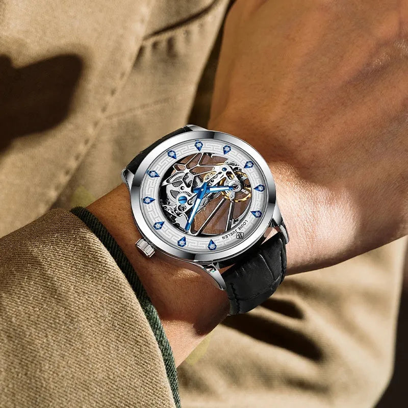 Men's silver mechanical watch with white dial, blue luminous hands, leather strap, and butterfly buckle