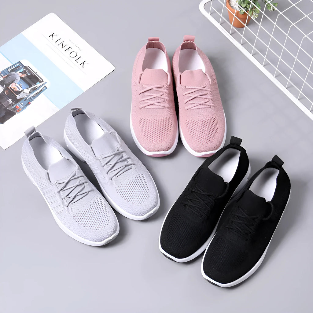 Women's black mesh casual sneaker with round toe and white non-slip PVC sole, shown from the side.