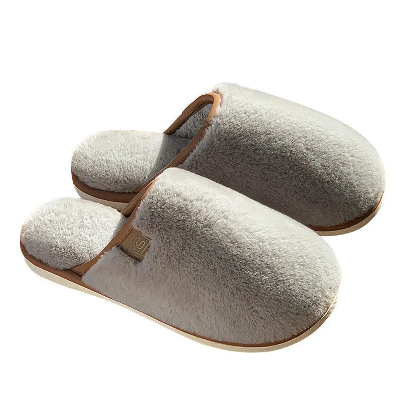 PVC non-slip winter slipper in a solid colour on a wooden floor.