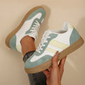 Women's green retro sports shoes with cross straps and leather stitching, low-top design with rubber sole