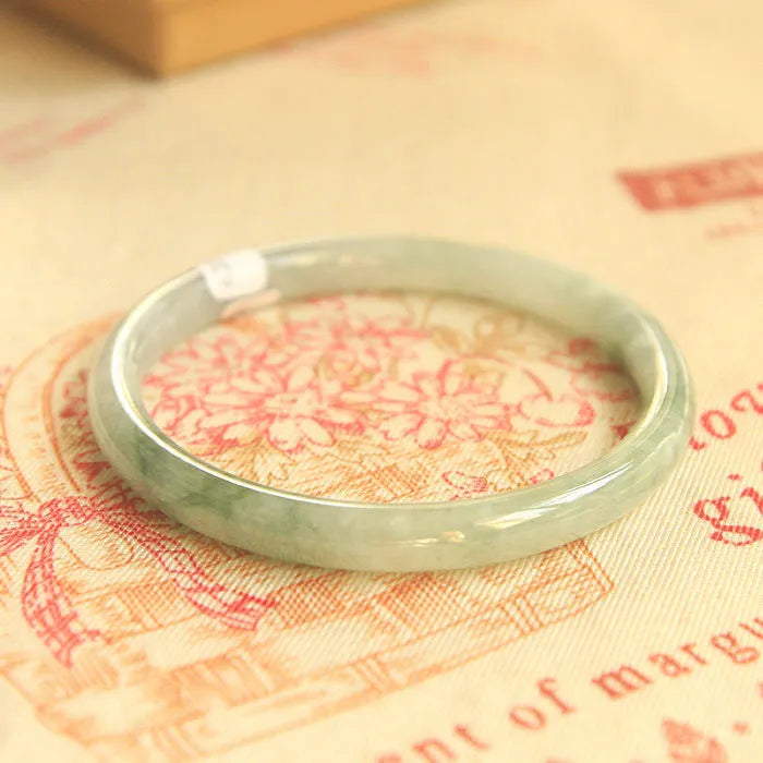Green jade geometric bracelet with waxy finish showing 10mm width and adjustable sizing