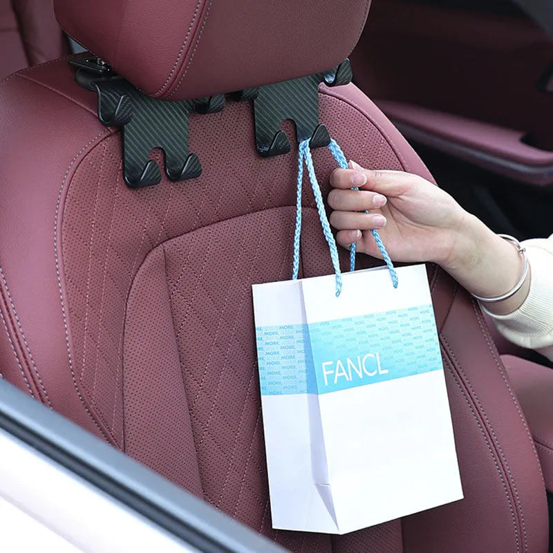 Black carbon fibre style car hook with integrated phone bracket measuring 11.5 by 8.1 by 4.7 centimetres