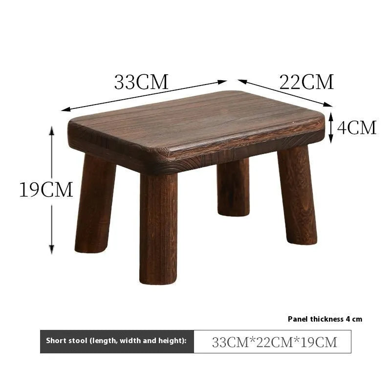 Solid wood shoes changing stool with distressed finish and bracket leg structure.