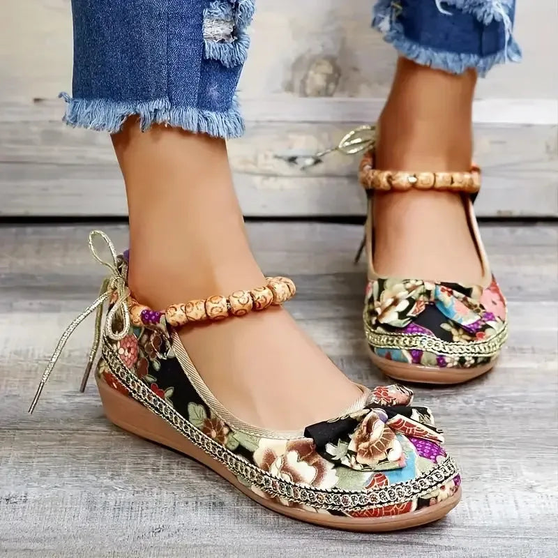 Women's plus size black ethnic platform sandals with elastic band and cloth upper.
