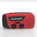 Red hand-crank emergency radio torch with solar panel, LED flashlight, and USB charging port.