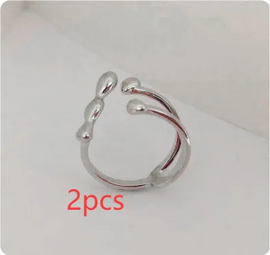 Brass opening ring with spherical design elements in gold finish