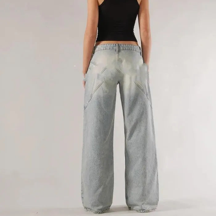 Women's blue cotton wide-leg mop trousers with a loose fit and low waist on a neutral background.