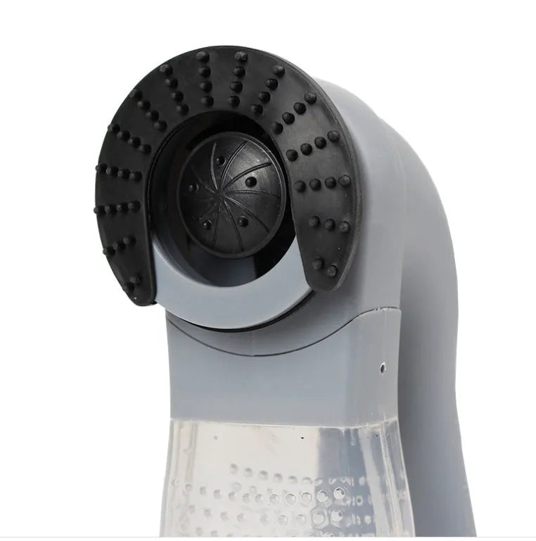 Gray portable electric pet hair remover with soft rubber head and collection canister.