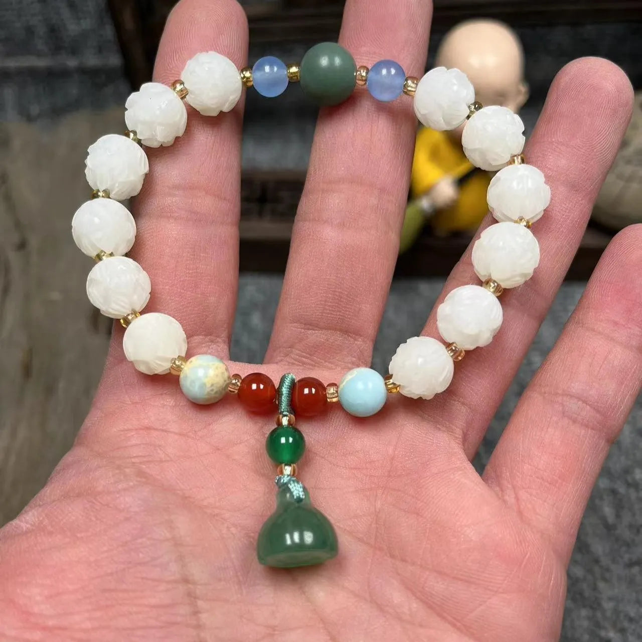 Carved pumpkin lotus bodhi root bracelet with white jade segments and golden silk jade treasures