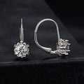 Close-up of a sterling silver flower bud clip earring with a moissanite centre, shown on a white background.