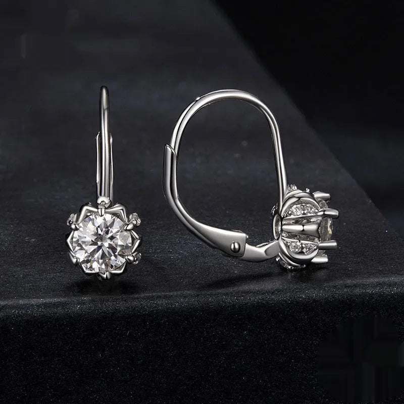 Close-up of a sterling silver flower bud clip earring with a moissanite centre, shown on a white background.