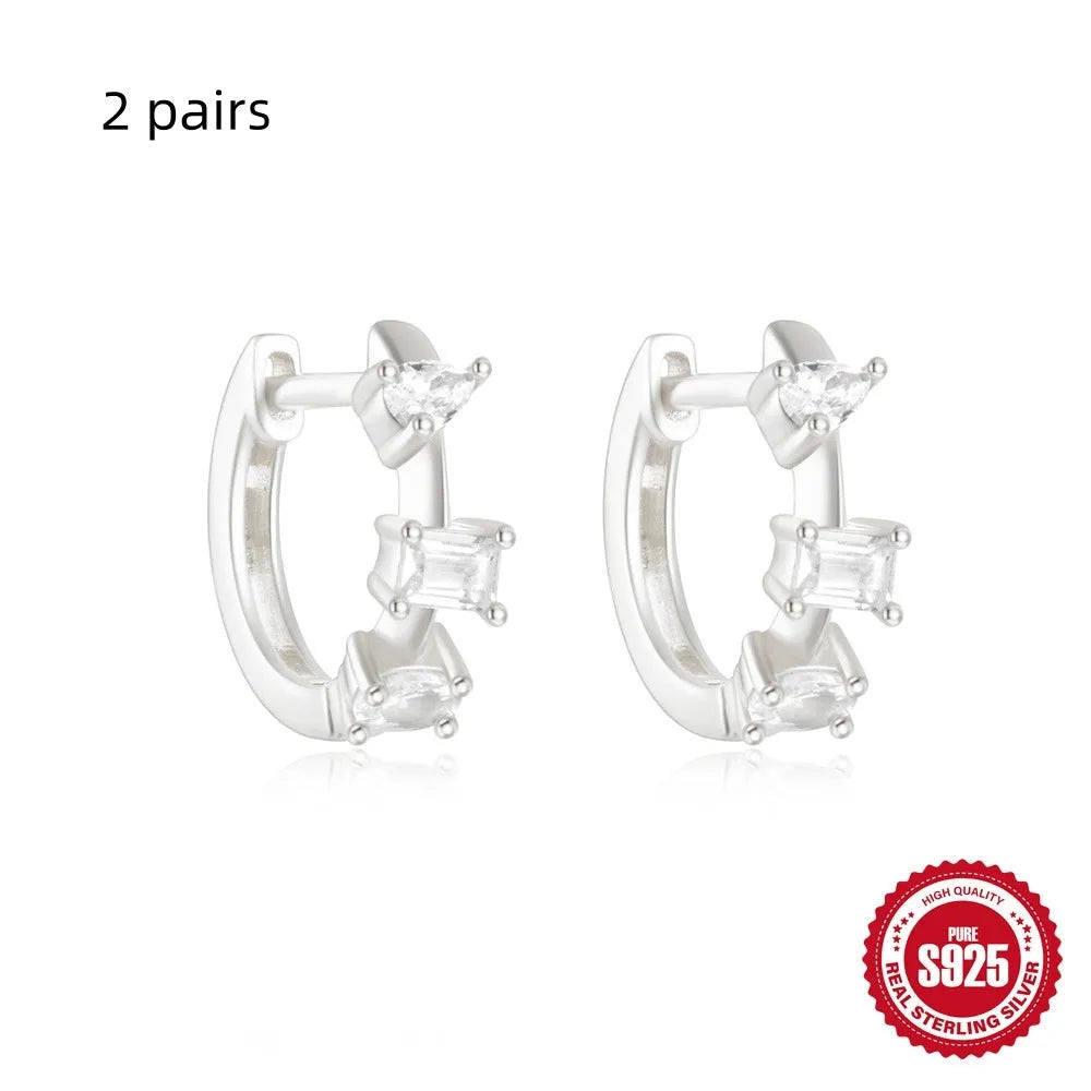 Small round geometric sterling silver stud earrings with a diamond shape, available in gold or silver finish.