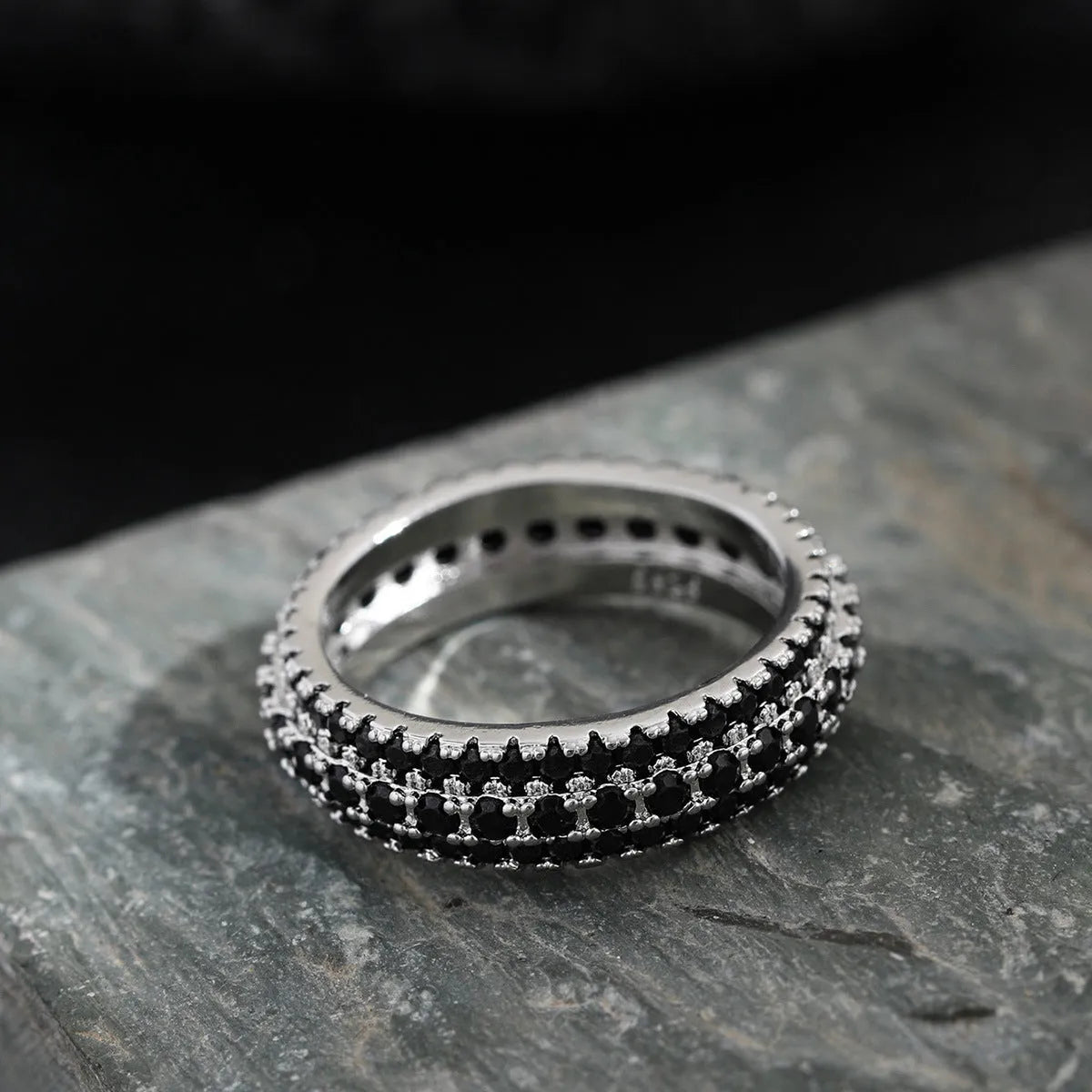 Geometric copper ring with triangular zircon stone, shown in white gold, yellow gold, and white and black finish options.