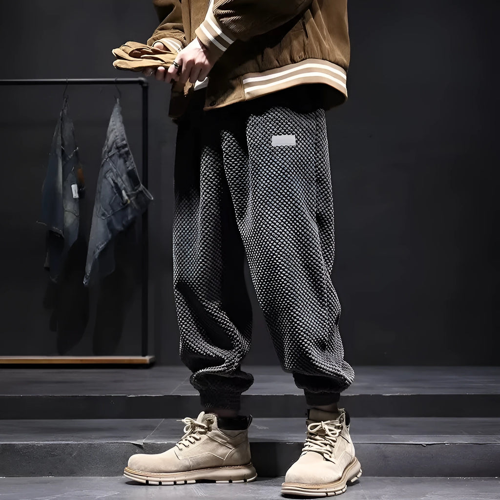 Men's grey straight-leg casual sweatpants with an ankle-tied design on a white background.