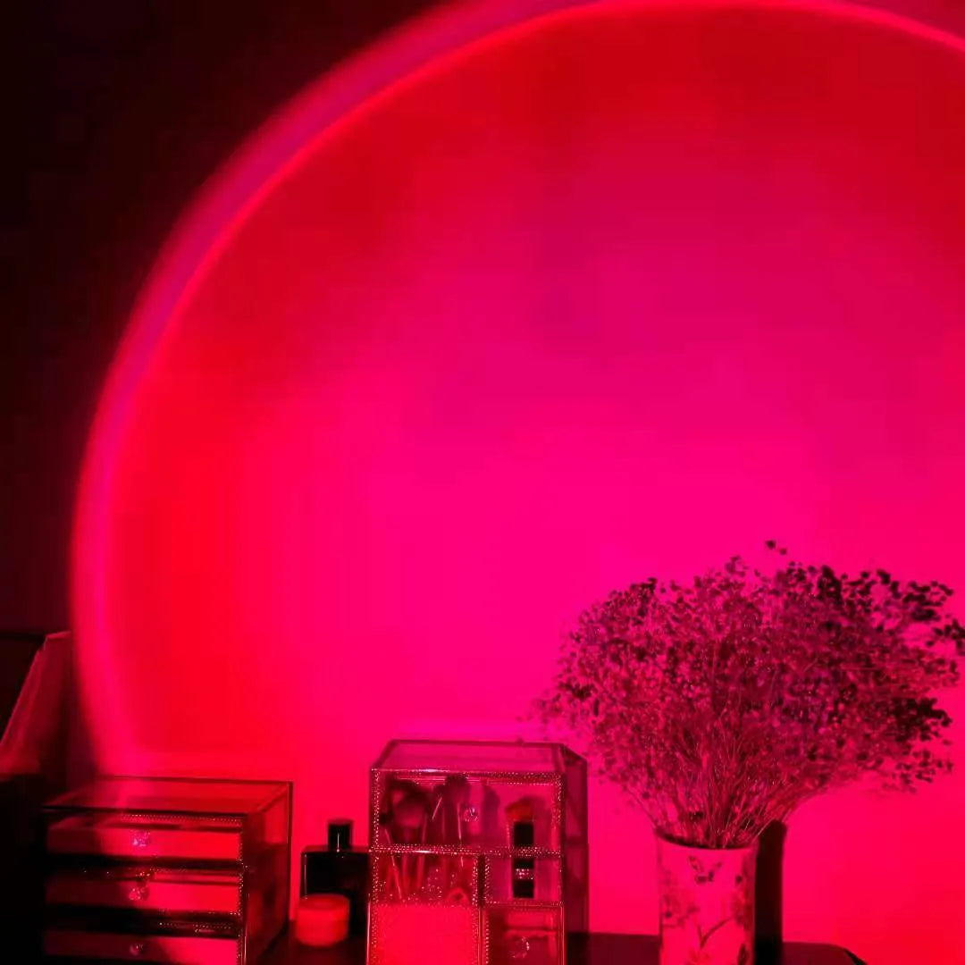 Rechargeable sunset projection lamp showing rainbow atmospheric lighting with USB power connector