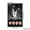 Short almond shaped false nails with black French tips, set of 24 pieces laid out.