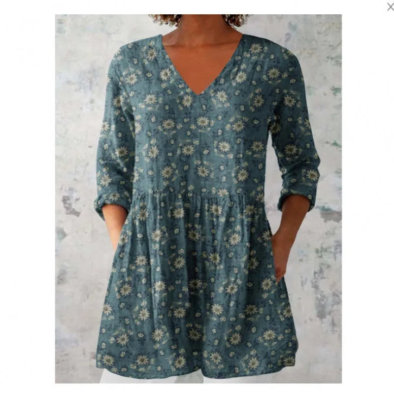 Women's printed wave pattern loose dress with wide waist and three-quarter length sleeves on a hanger.