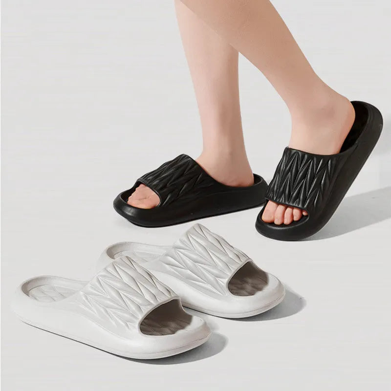 Pair of leaf-textured EVA indoor slippers on a solid background, showing non-slip sole.