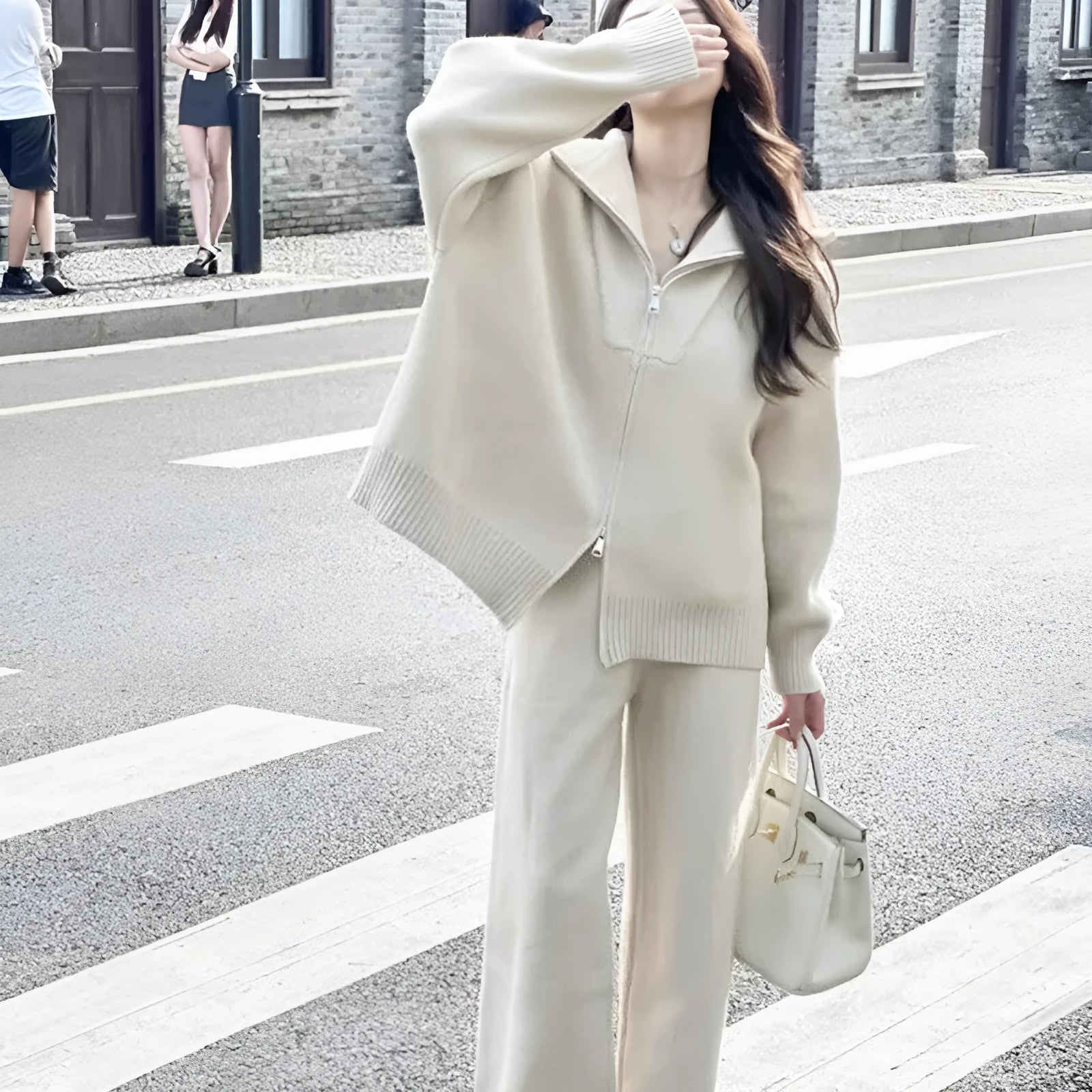 Women's solid colour polyester two-piece set featuring a knitted zipper cardigan and wide leg trousers.