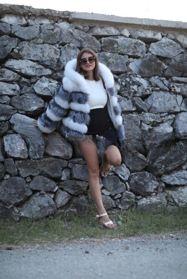 Women's loose brown artificial fur hooded coat on a hanger, street fashion style.
