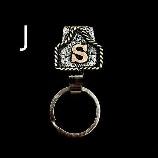 Handmade metal cow tag belt key holder keychain on a key ring, showing the metal loop and tag design.