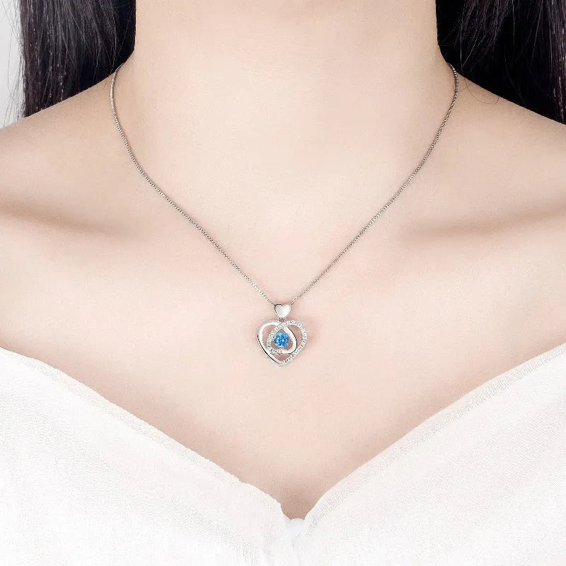 Blue diamond heart necklace and bracelet set with adjustable chain on display