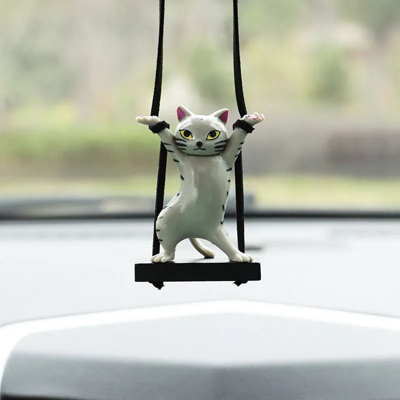 Cartoon style resin cat pendant on a rope for hanging in a car, shown in multiple colour options.