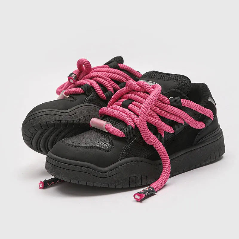 Pair of thick-soled casual lace-up shoes in a solid colour on a white background.