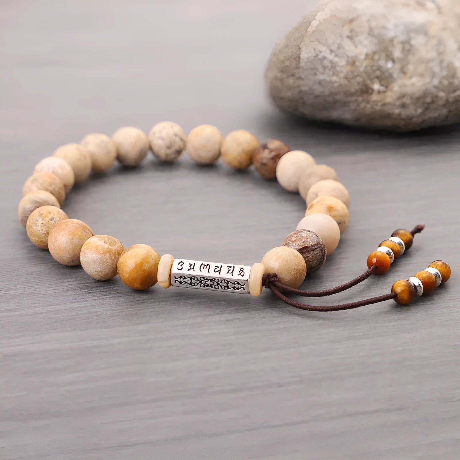 Handmade stone bead bracelet in wood colour on a simple background, showing retro style design.