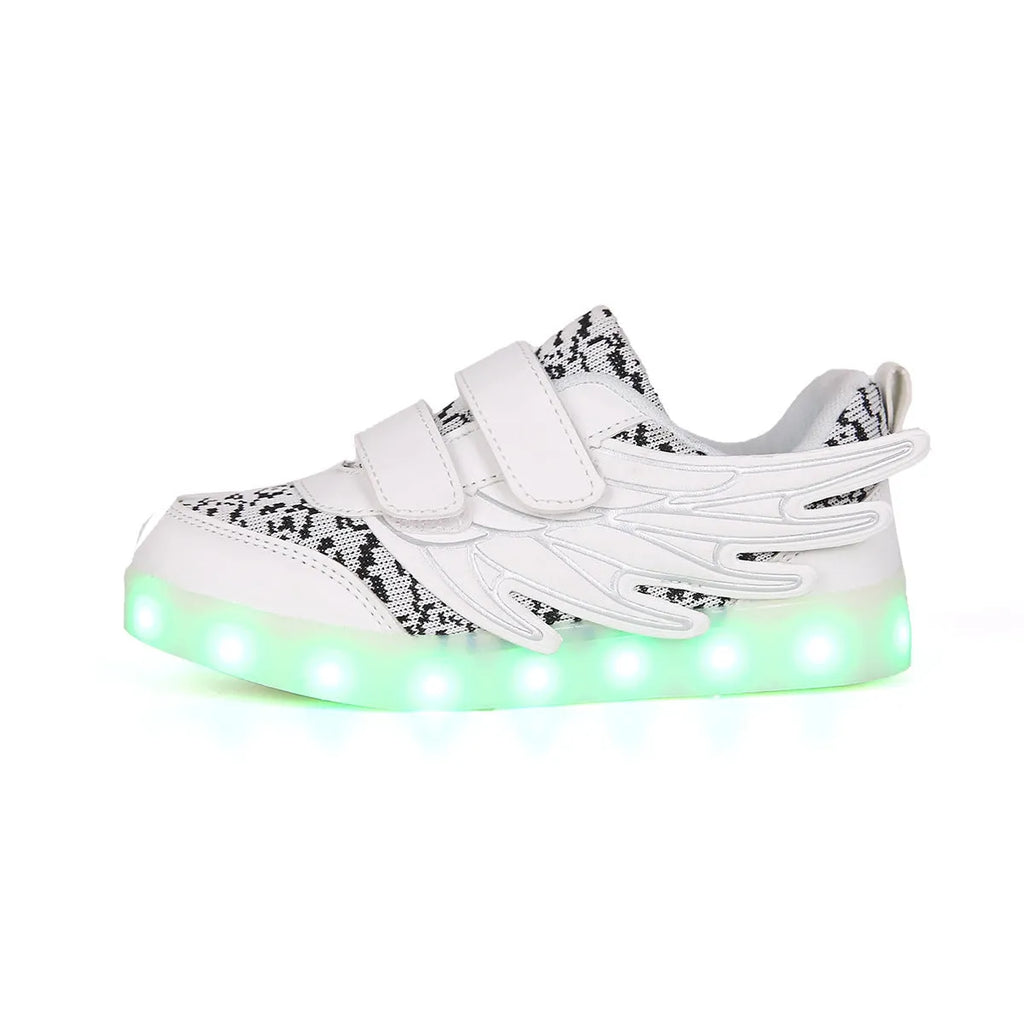 Children's plum red sneakers with multicolour LED lights glowing on the soles.